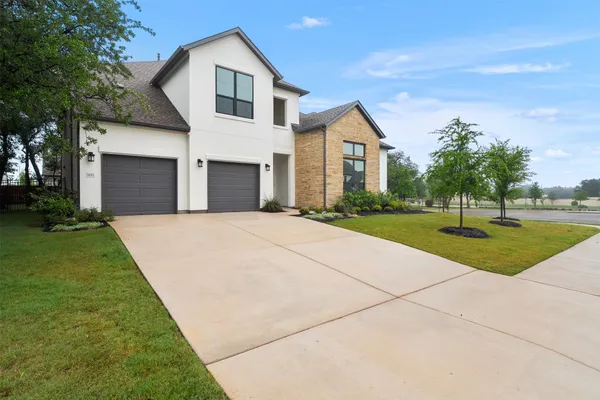 a front view of house with yard and green space