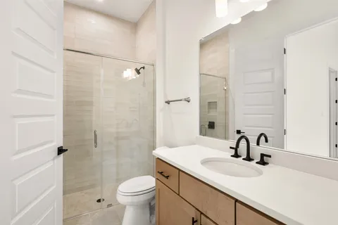 a bathroom with a sink toilet and shower