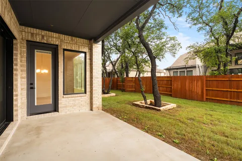 a front view of a house with a yard and trees
