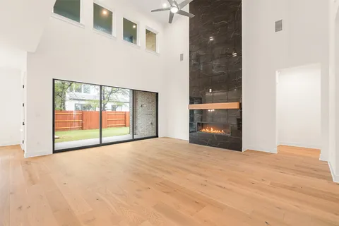 a view of an empty room with a window and bathroom
