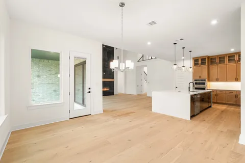 a view of a kitchen with refrigerator and white cabinets