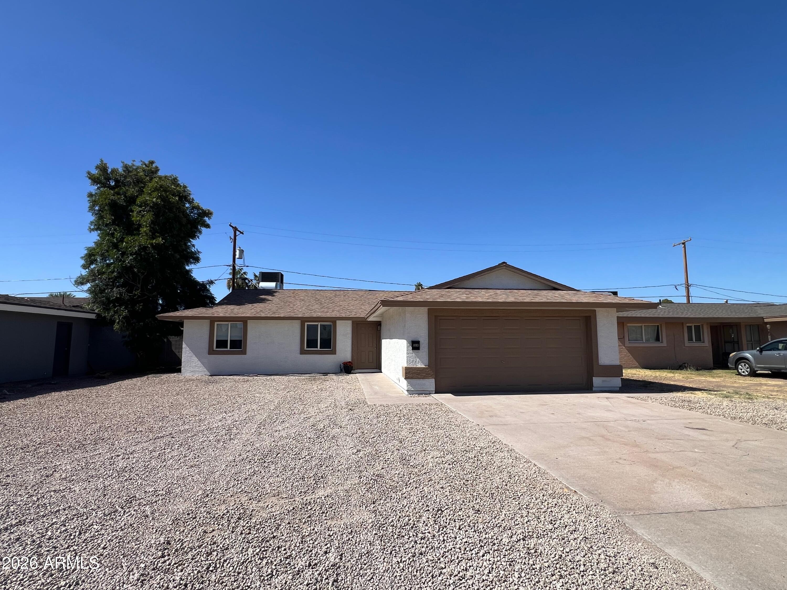 3818 West Ruth Avenue Phoenix, AZ 85051 - Photo 11 of 20 a front view of a house with a yard