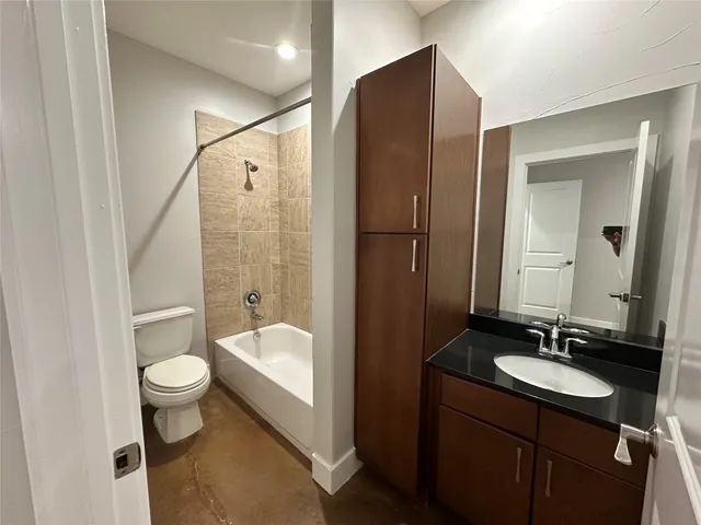 a bathroom with a double vanity sink toilet mirror and shower
