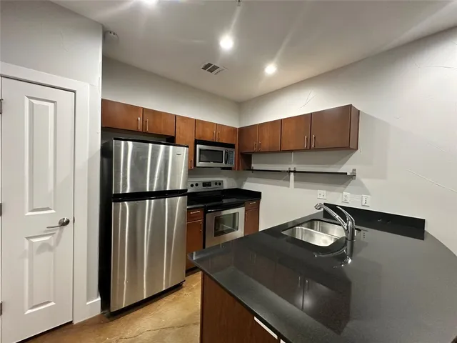 a kitchen with a sink a stove and refrigerator