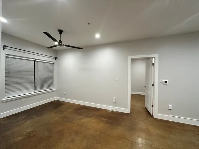 an empty room with a empty space and windows