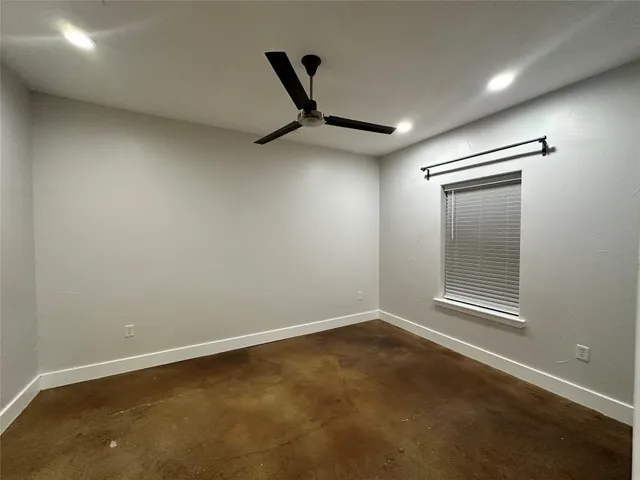 a view of a livingroom with a ceiling fan and wooden floor