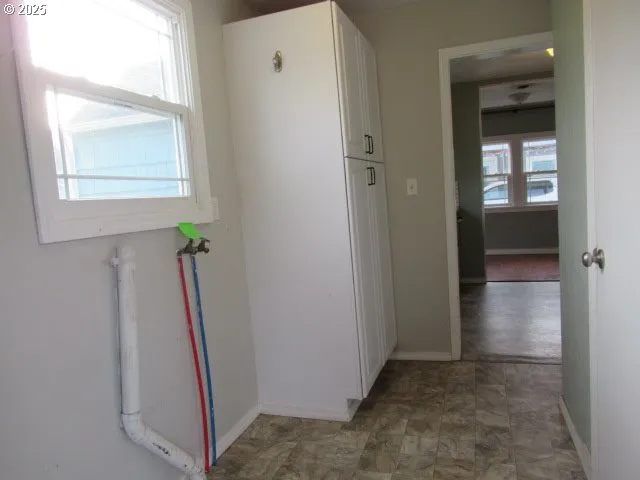a view of a hallway with a door and a mirror