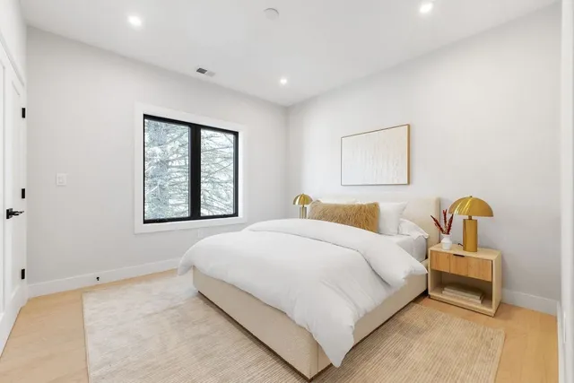 a bedroom with bed and window