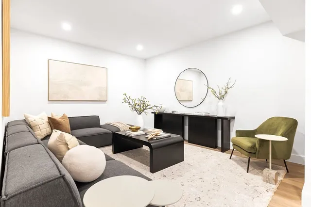 a living room with a couch and potted plant