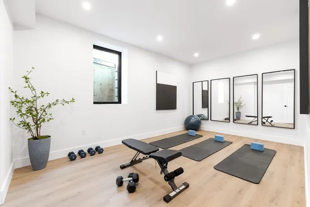 a view of a house with a yard and a tree