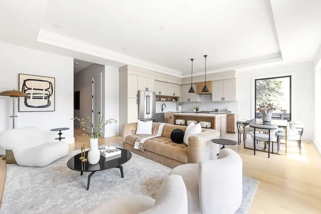 a living room with furniture a dining table and a window