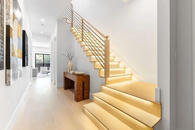 a view of entryway and hall with wooden floor