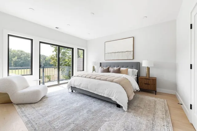 a bedroom with a bed and a large window