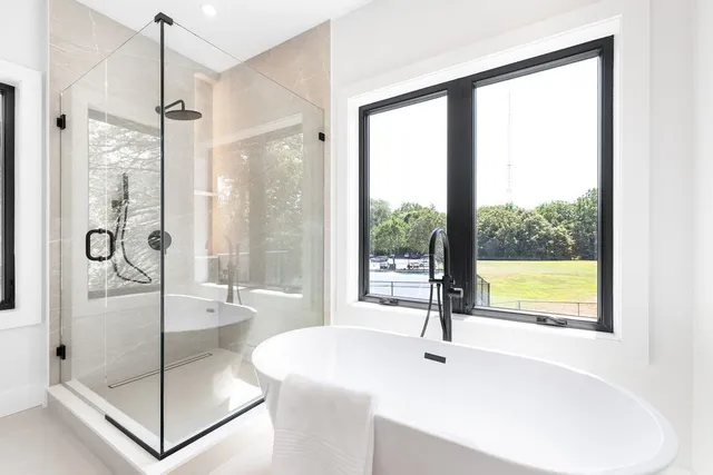 a bathroom with a tub and shower