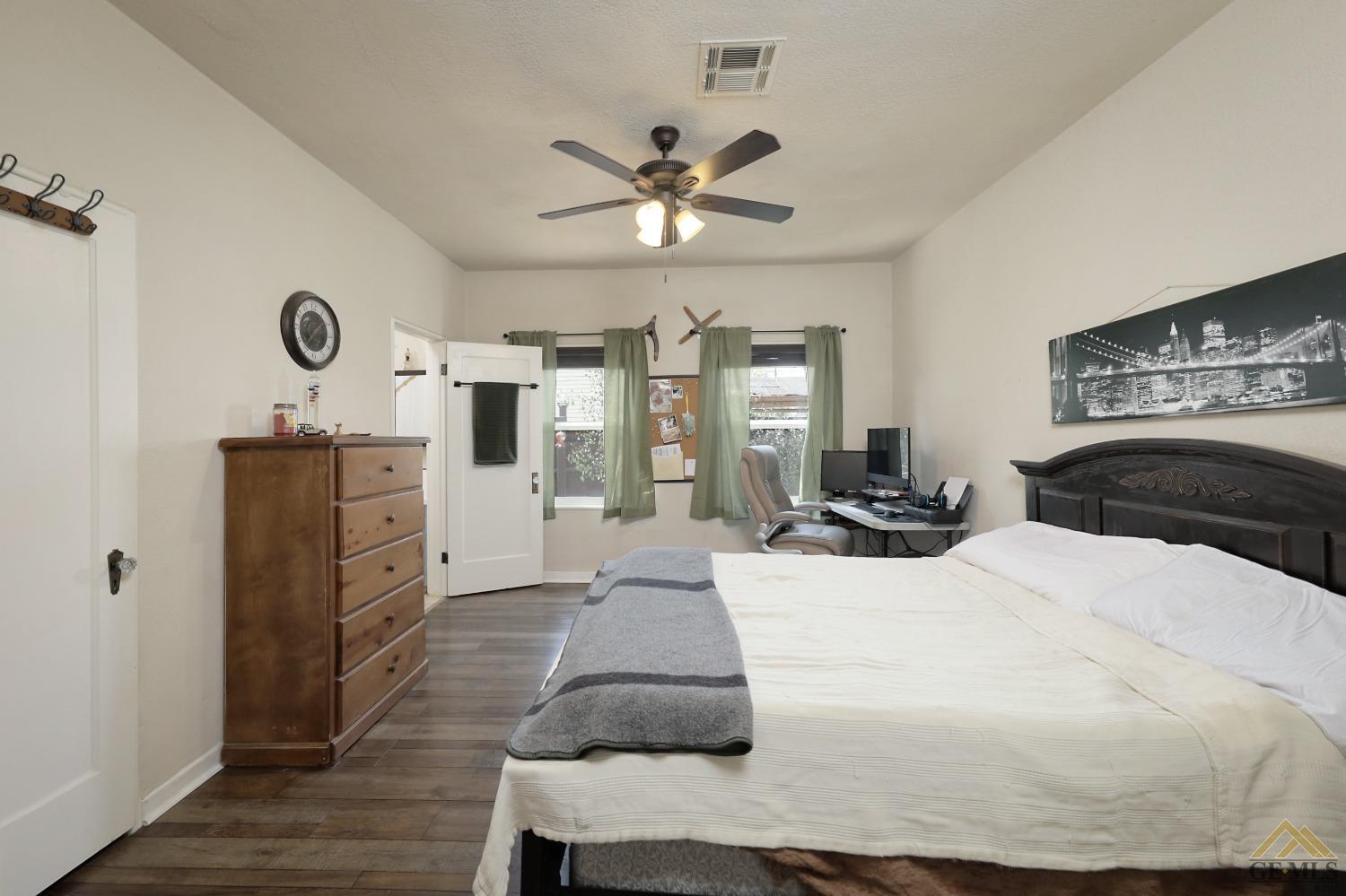 Undisclosed Address Bakersfield, CA 93305 - Photo 12 of 29 a bedroom with a bed and wooden floor