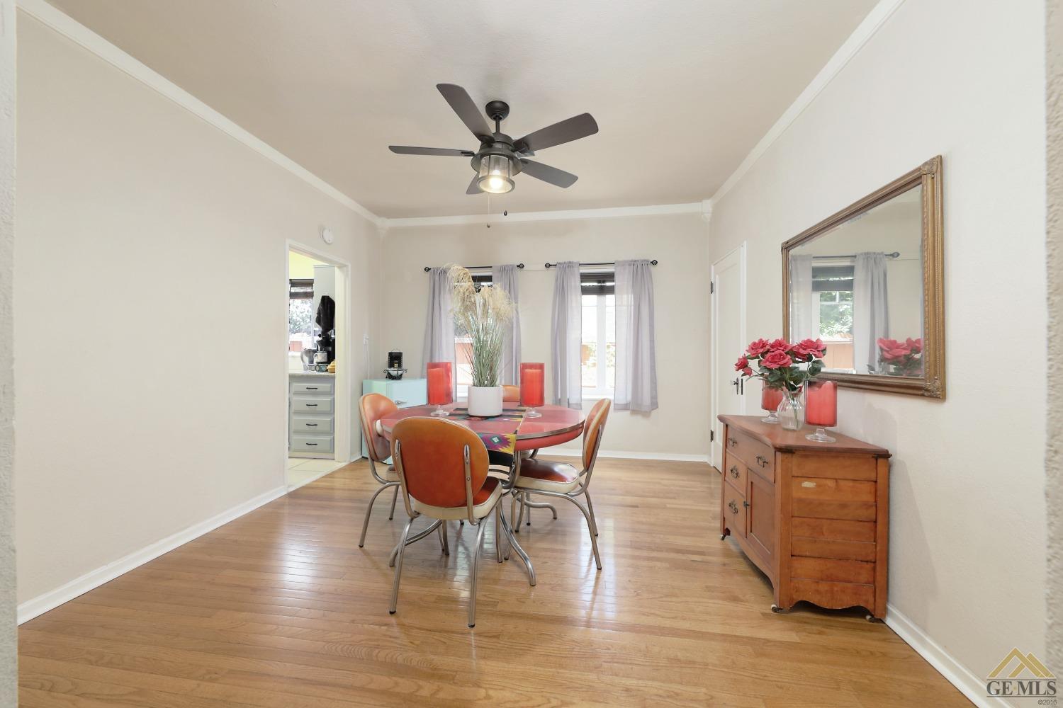 Undisclosed Address Bakersfield, CA 93305 - Photo 18 of 29 a dining room with furniture a potted plant and wooden floor
