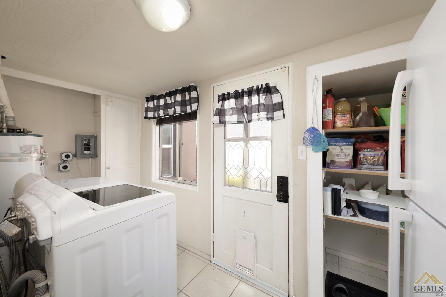 Undisclosed Address Bakersfield, CA 93305 - Photo 20 of 29 a kitchen that has a lot of cabinets and wooden floor