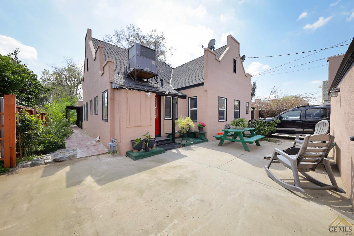 Undisclosed Address Bakersfield, CA 93305 - Photo 21 of 29 a view of a patio with a table and chairs under an umbrella
