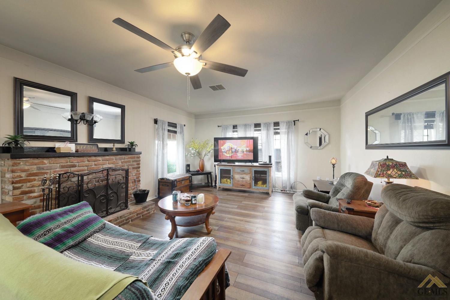 Undisclosed Address Bakersfield, CA 93305 - Photo 7 of 29 a living room with furniture and a fireplace