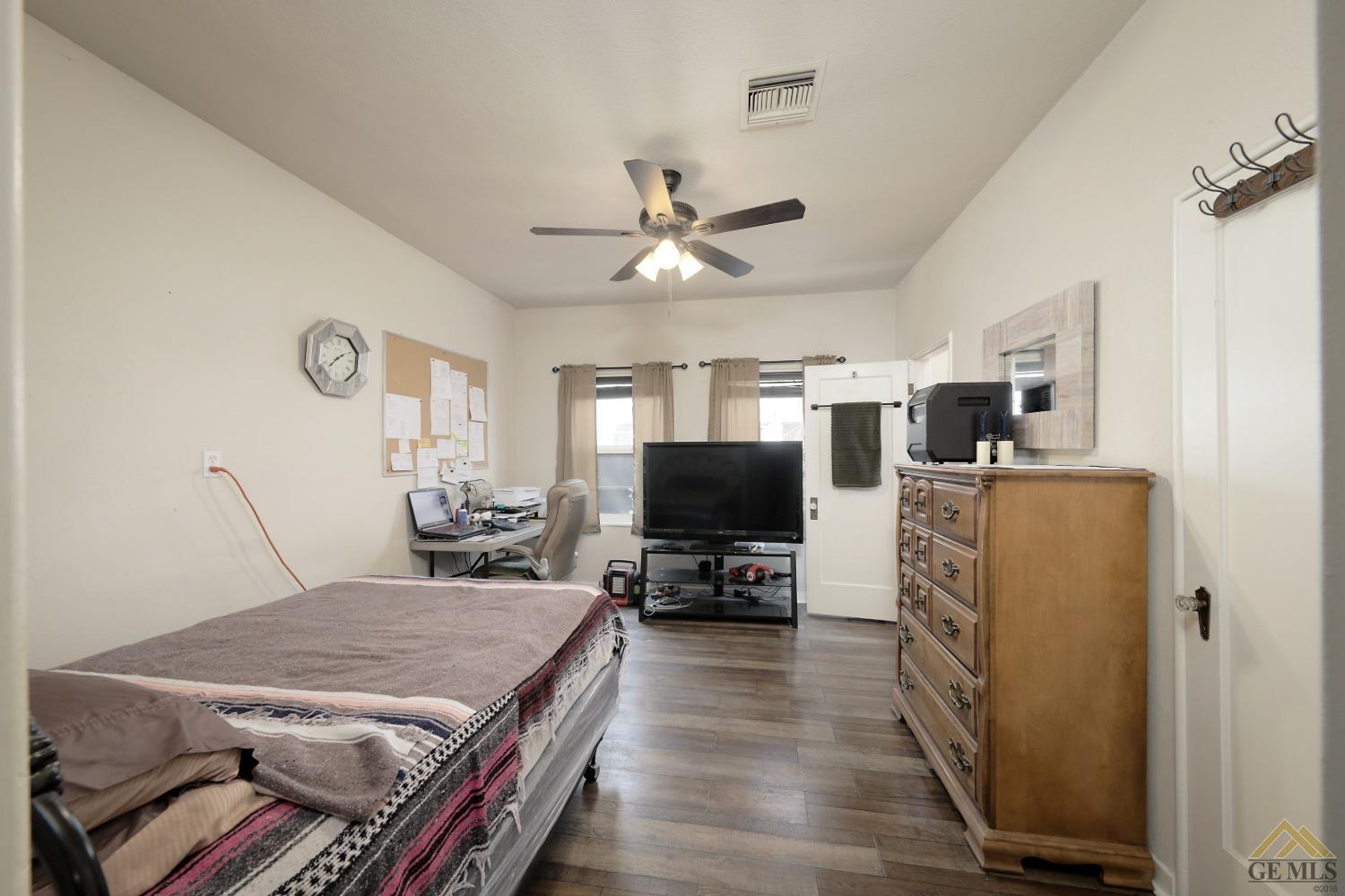 Undisclosed Address Bakersfield, CA 93305 - Photo 10 of 29 a living room with furniture and a flat screen tv