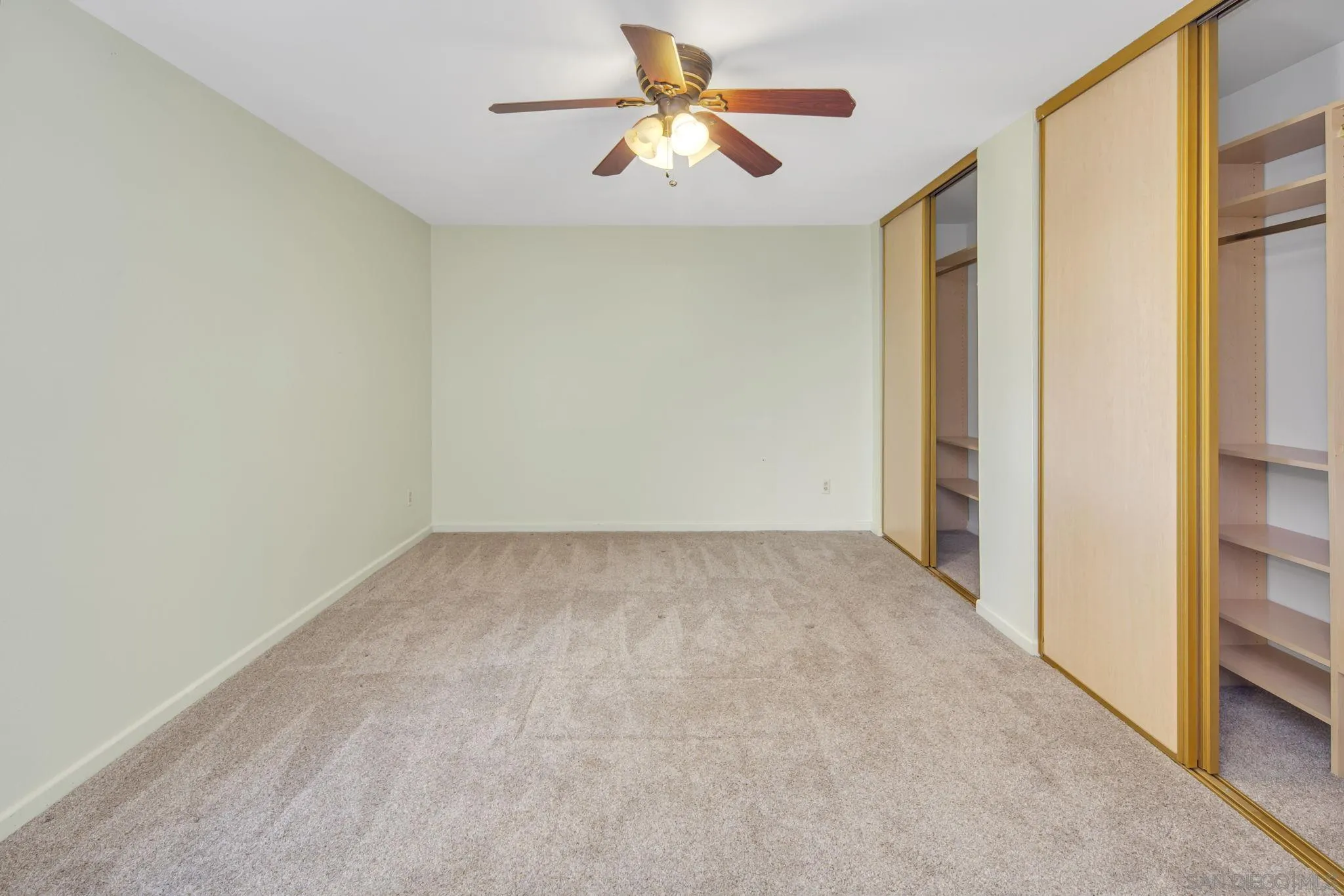 12544 Rios Road San Diego, CA 92128 - Photo 12 of 25 a view of a big room with closet and a chandelier fan
