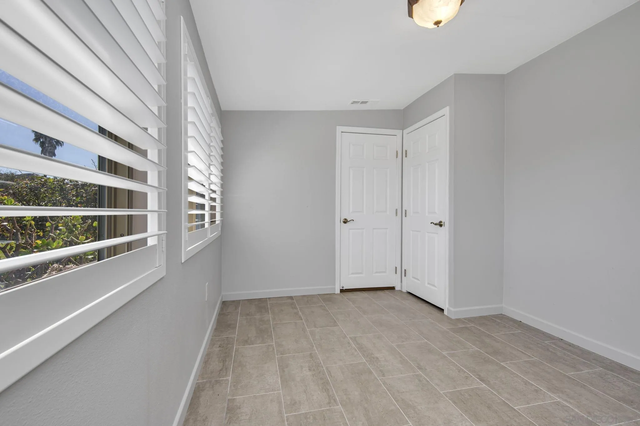 12544 Rios Road San Diego, CA 92128 - Photo 17 of 25 a view of an empty room with a window
