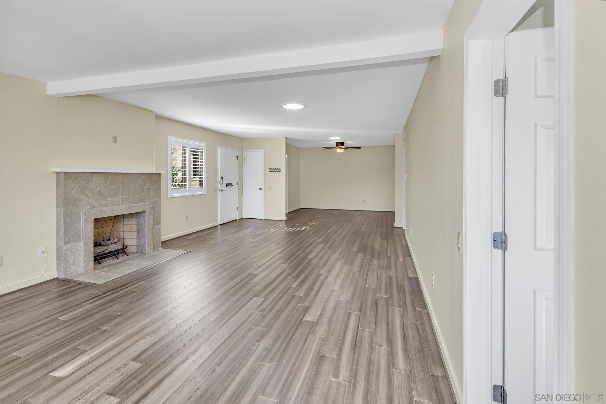 12544 Rios Road San Diego, CA 92128 - Photo 4 of 25 a view of empty room with wooden floor and fireplace