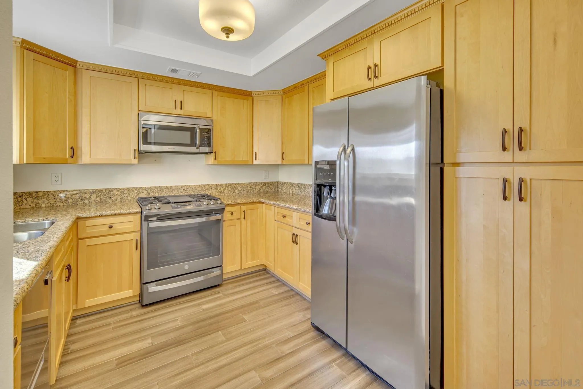 12544 Rios Road San Diego, CA 92128 - Photo 7 of 25 a kitchen with stainless steel appliances a refrigerator sink and microwave