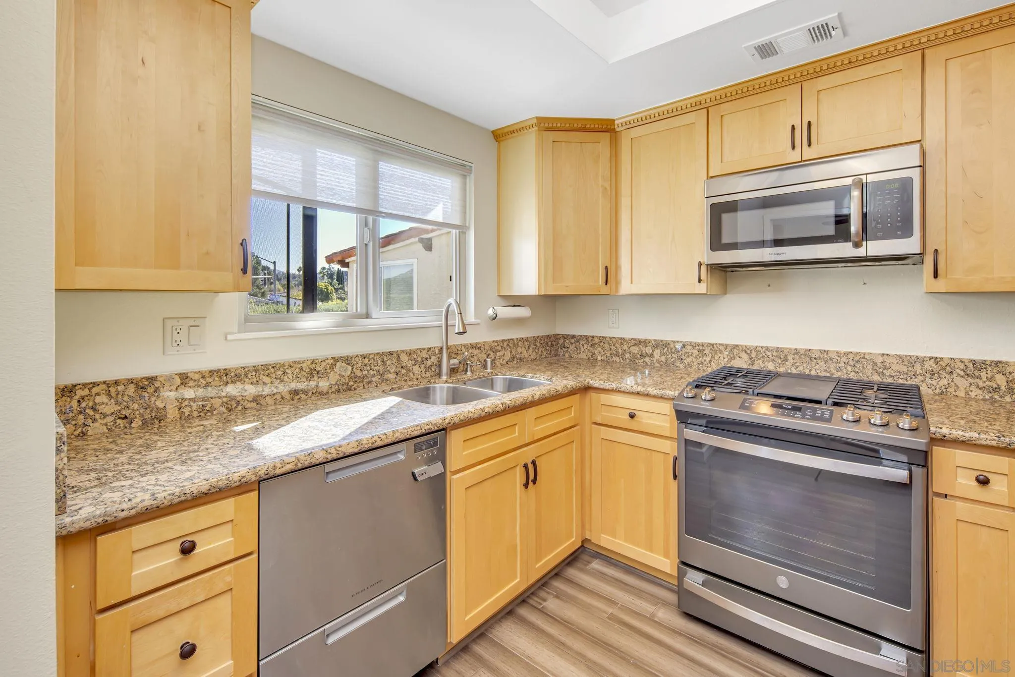 12544 Rios Road San Diego, CA 92128 - Photo 8 of 25 a kitchen with granite countertop cabinets stainless steel appliances and a sink