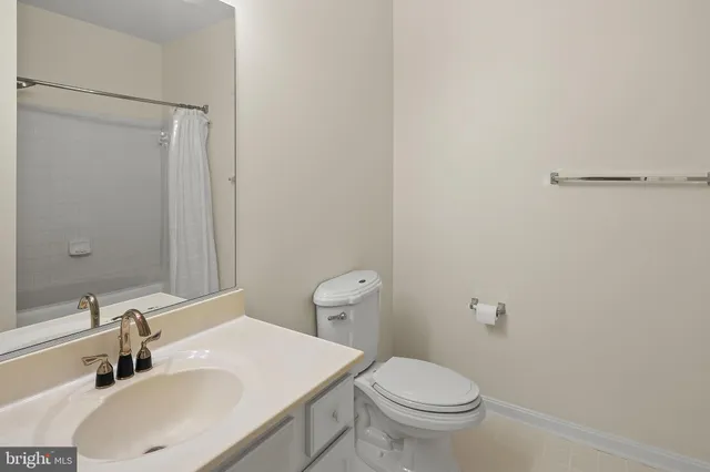a bathroom with a sink toilet and a mirror