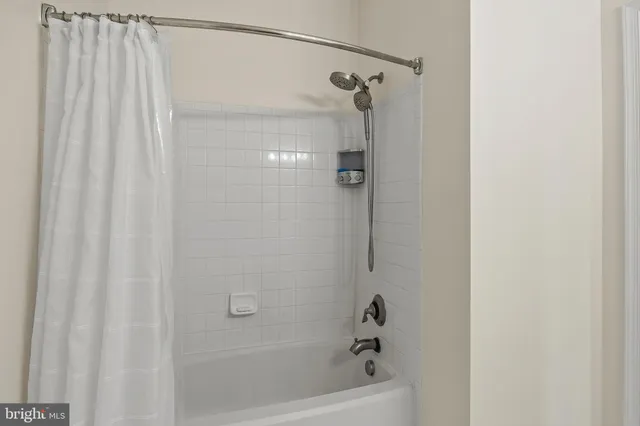 a bathroom with a shower and a bath tub