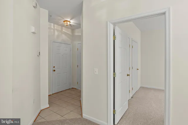 a view of a bathroom from the hallway with hallway
