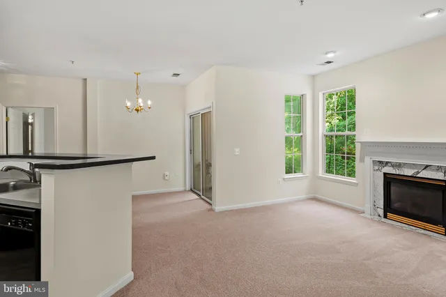 a view of empty room with a fireplace