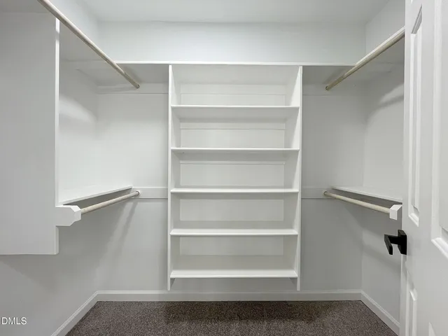 an empty room with a empty space and windows