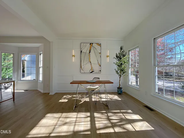 a workspace room with furniture and wooden floor