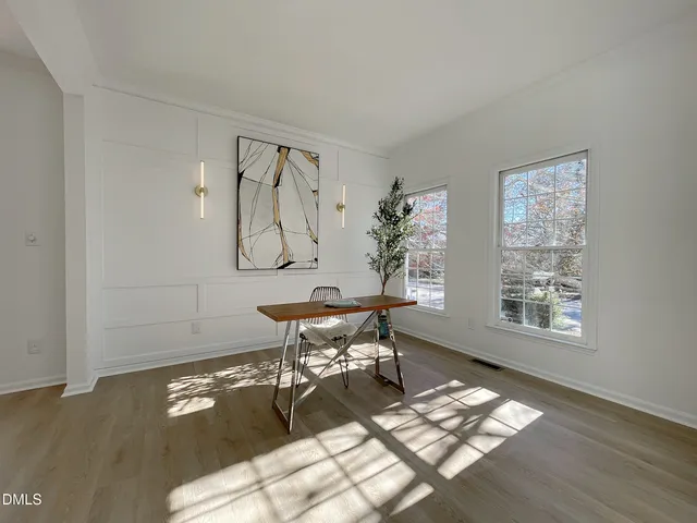 a view of a dining room with furniture window and wooden floor