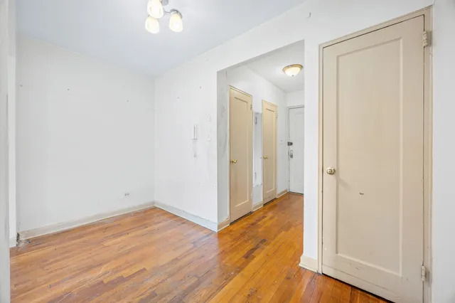 a view of a room with wooden floor