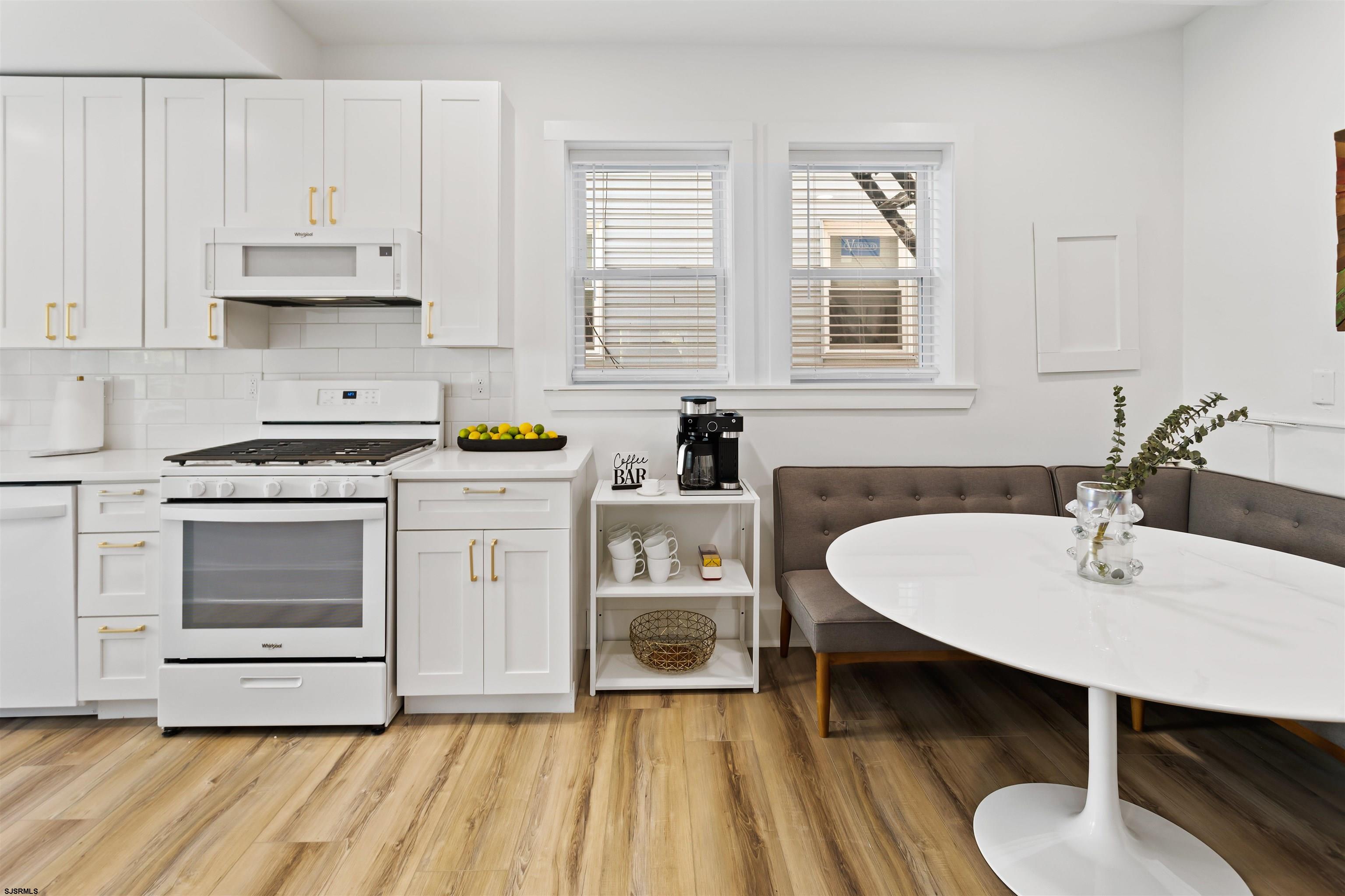 1 South Delancy Place, Unit 1 Atlantic City, NJ 08401 - Photo 23 of 35 a kitchen with a sink cabinets and wooden floor