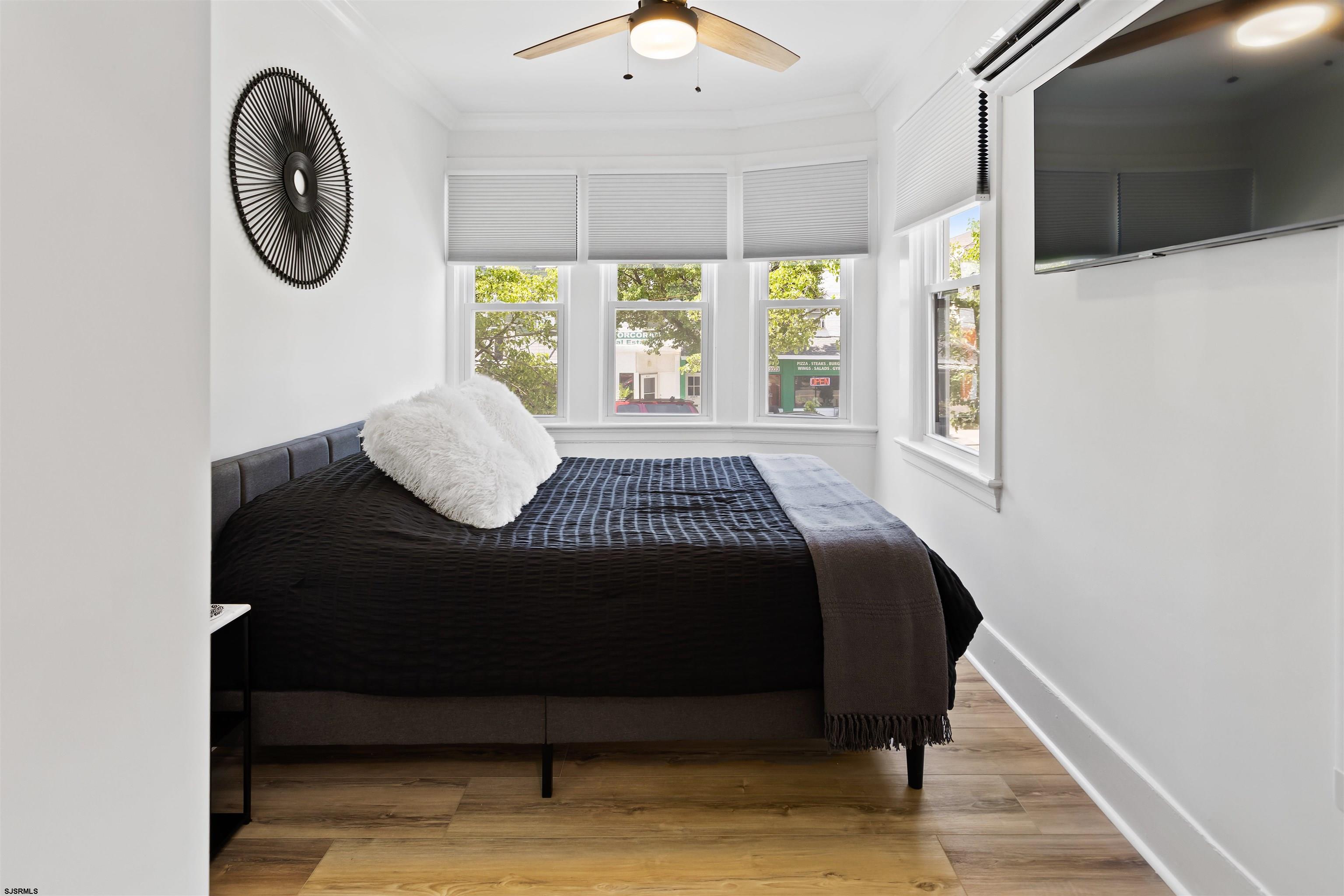 1 South Delancy Place, Unit 1 Atlantic City, NJ 08401 - Photo 24 of 35 a bedroom with a bed mirror and window