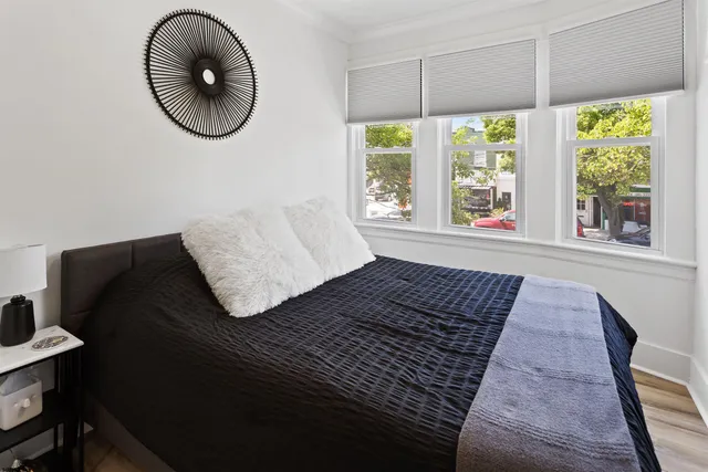 a living room with a rug and a large window