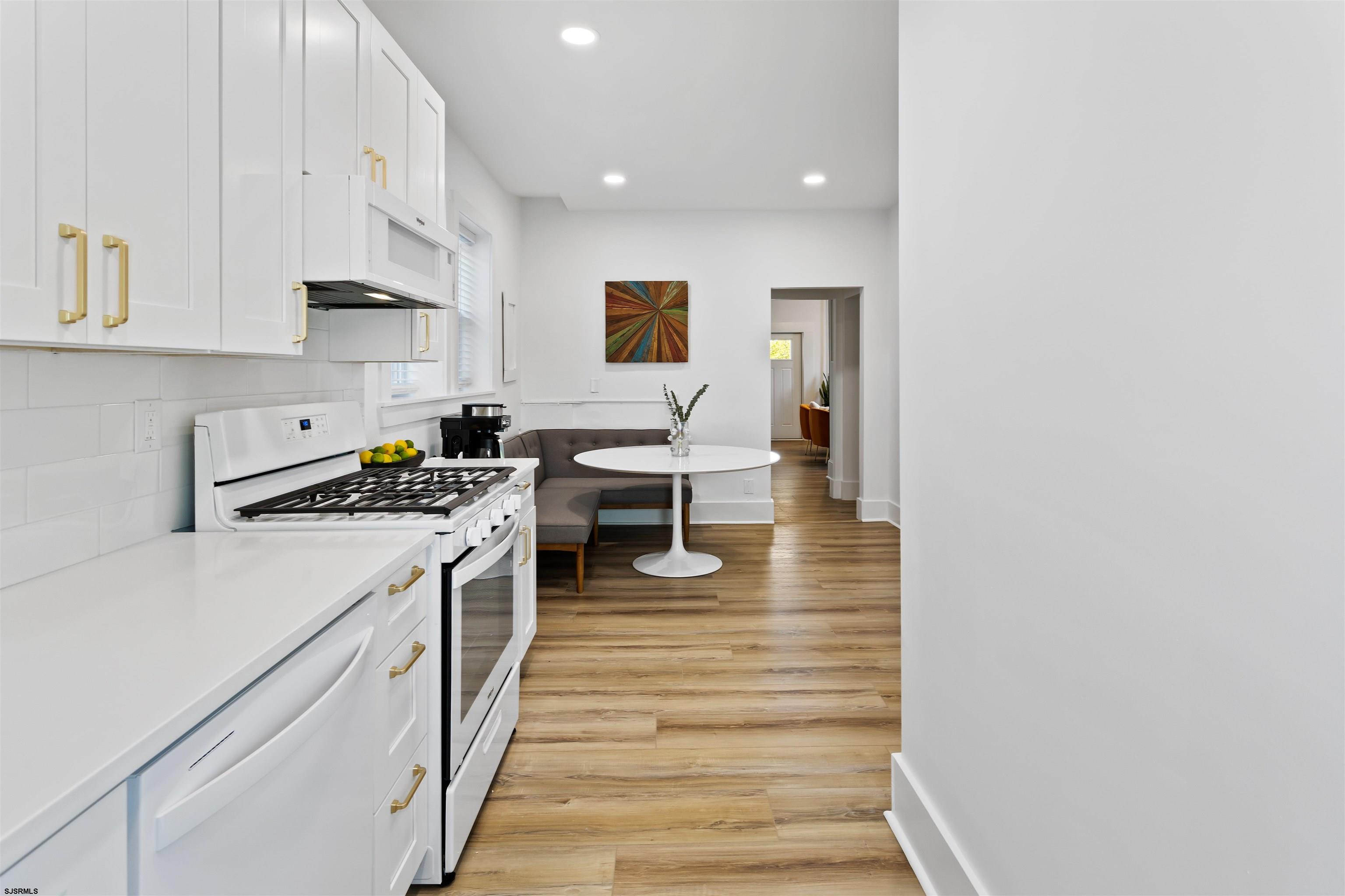 1 South Delancy Place, Unit 1 Atlantic City, NJ 08401 - Photo 32 of 35 a kitchen with white cabinets and white appliances