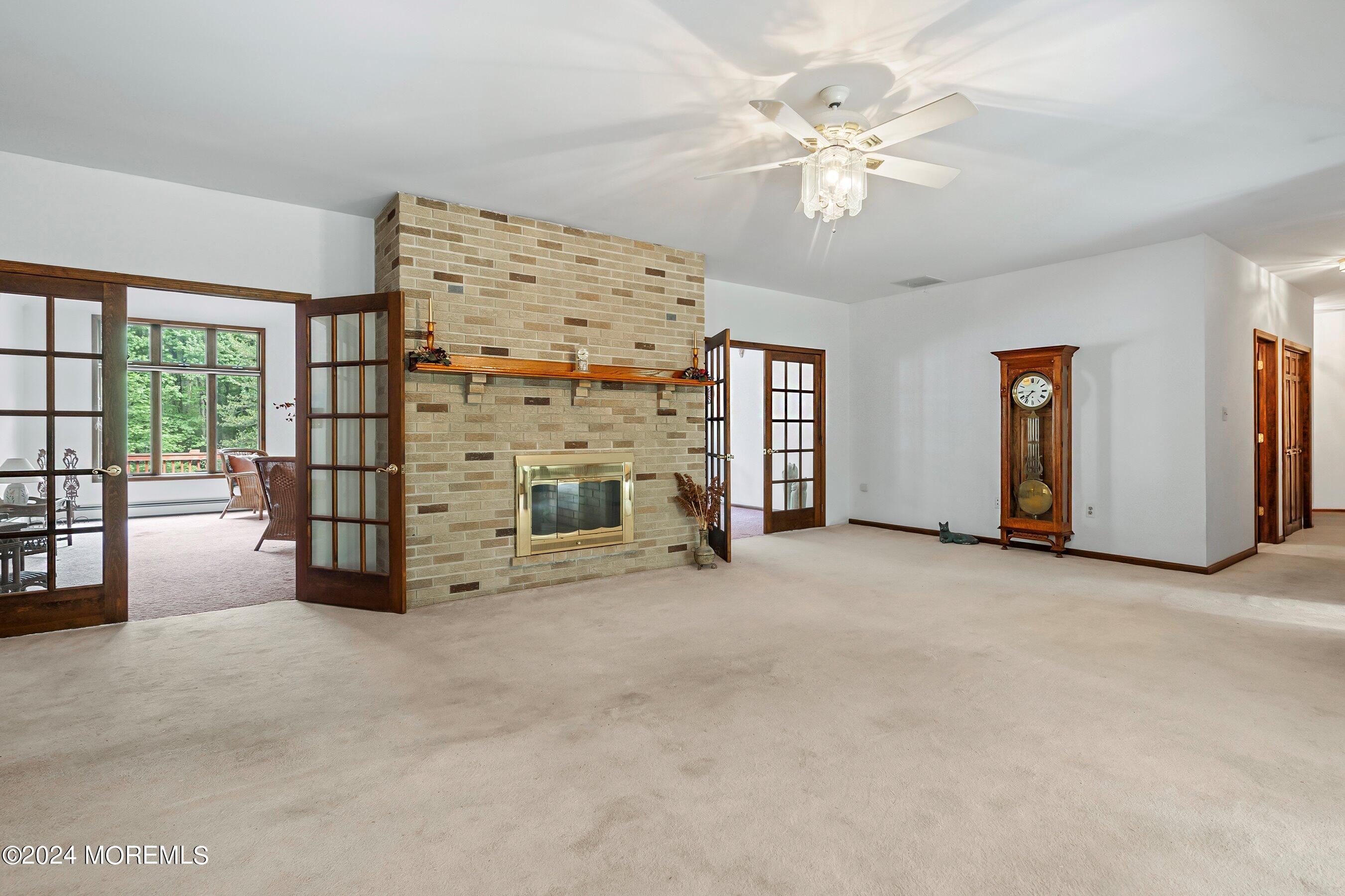 859 Monmouth Road Cream Ridge, NJ 08514 - Photo 13 of 50 a view of an empty room with fireplace and a window