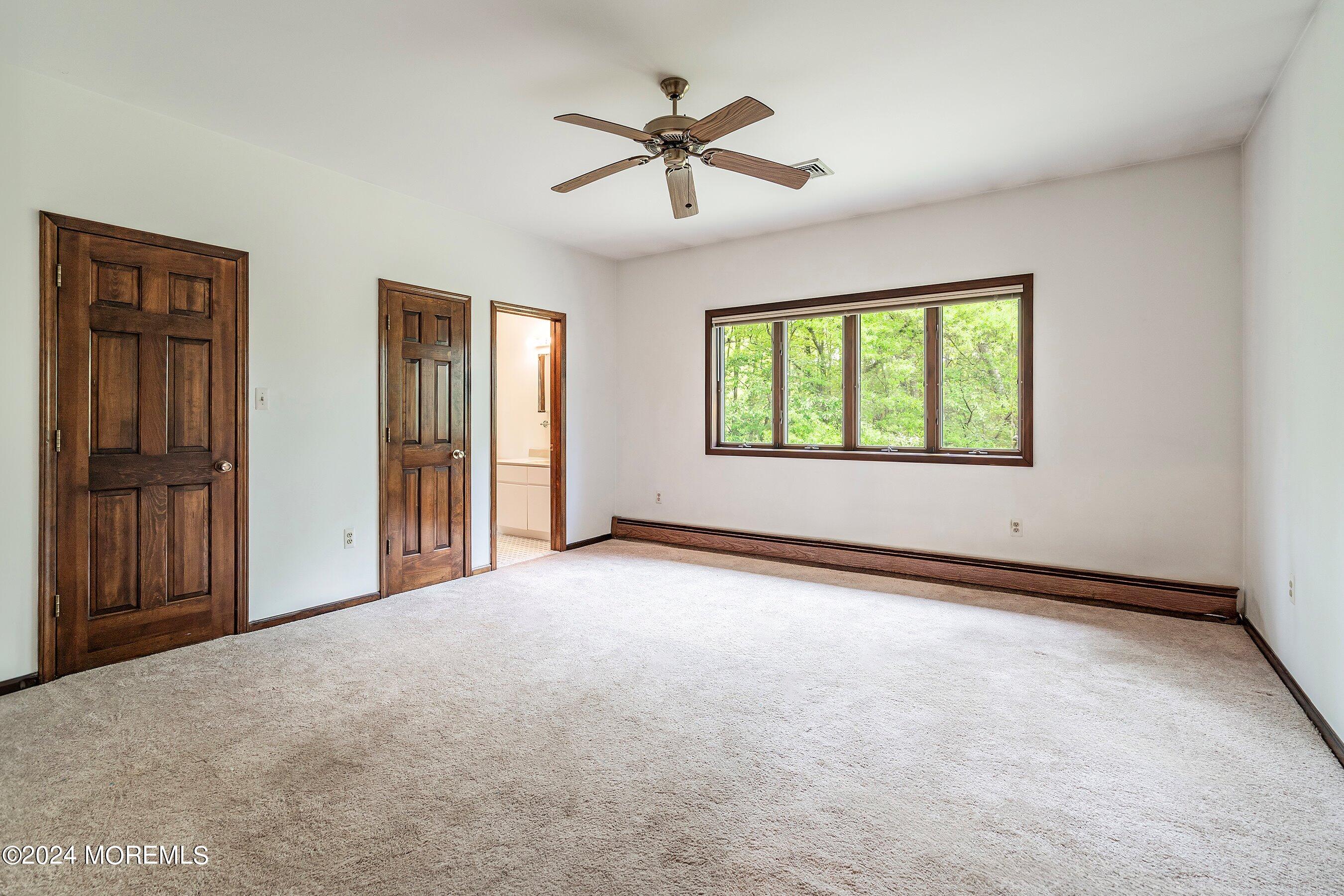 859 Monmouth Road Cream Ridge, NJ 08514 - Photo 20 of 50 an empty room with windows and ceiling fan