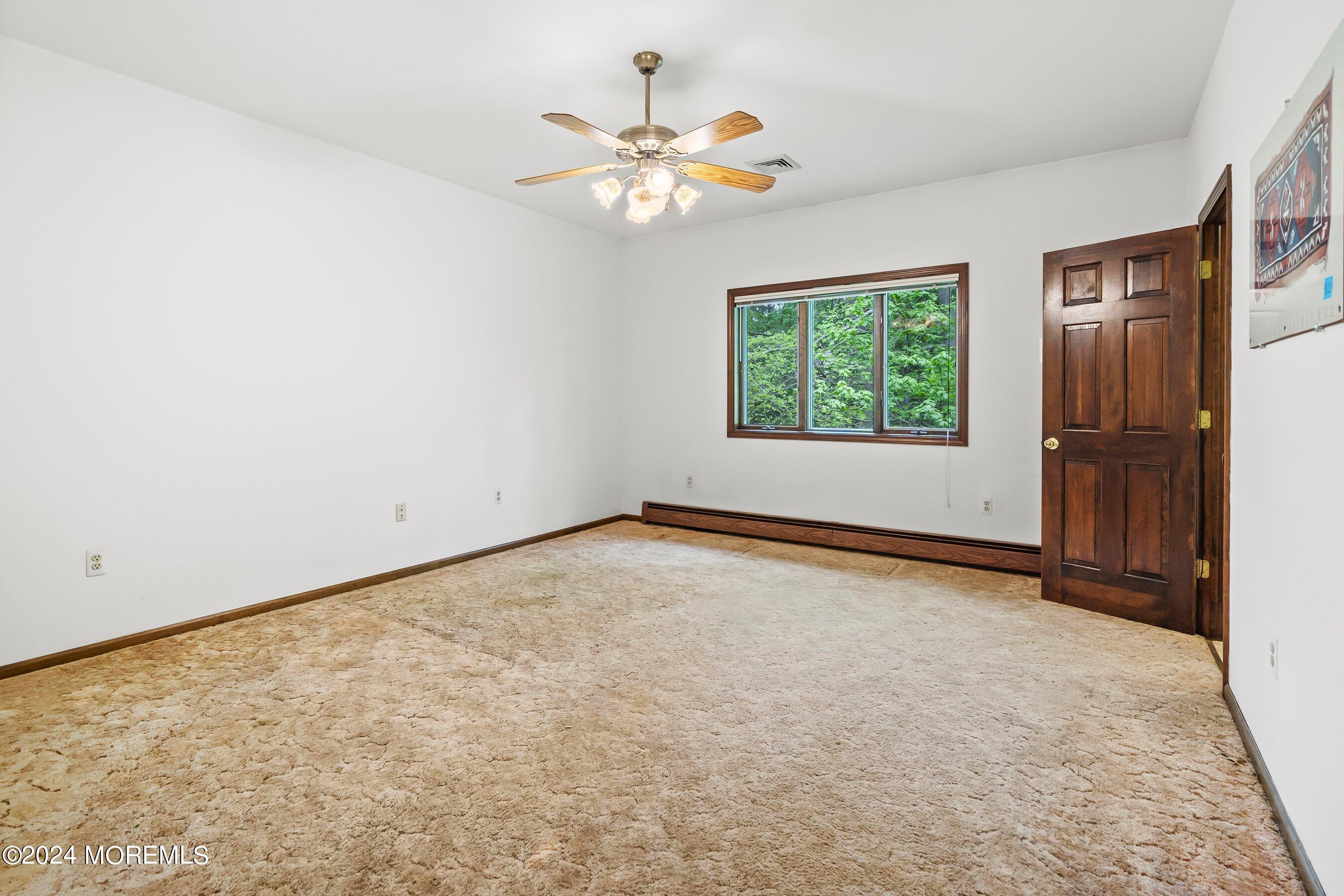 859 Monmouth Road Cream Ridge, NJ 08514 - Photo 23 of 50 an empty room with windows and fan