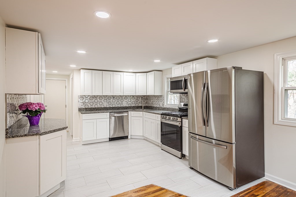 a kitchen with stainless steel appliances a refrigerator sink and cabinets