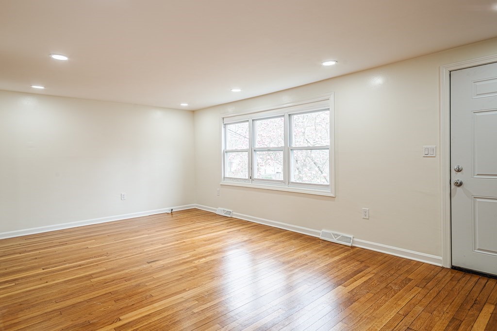 39 Kalmia Road Holbrook, MA 02343 - Photo 8 of 32 an empty room with wooden floor and windows