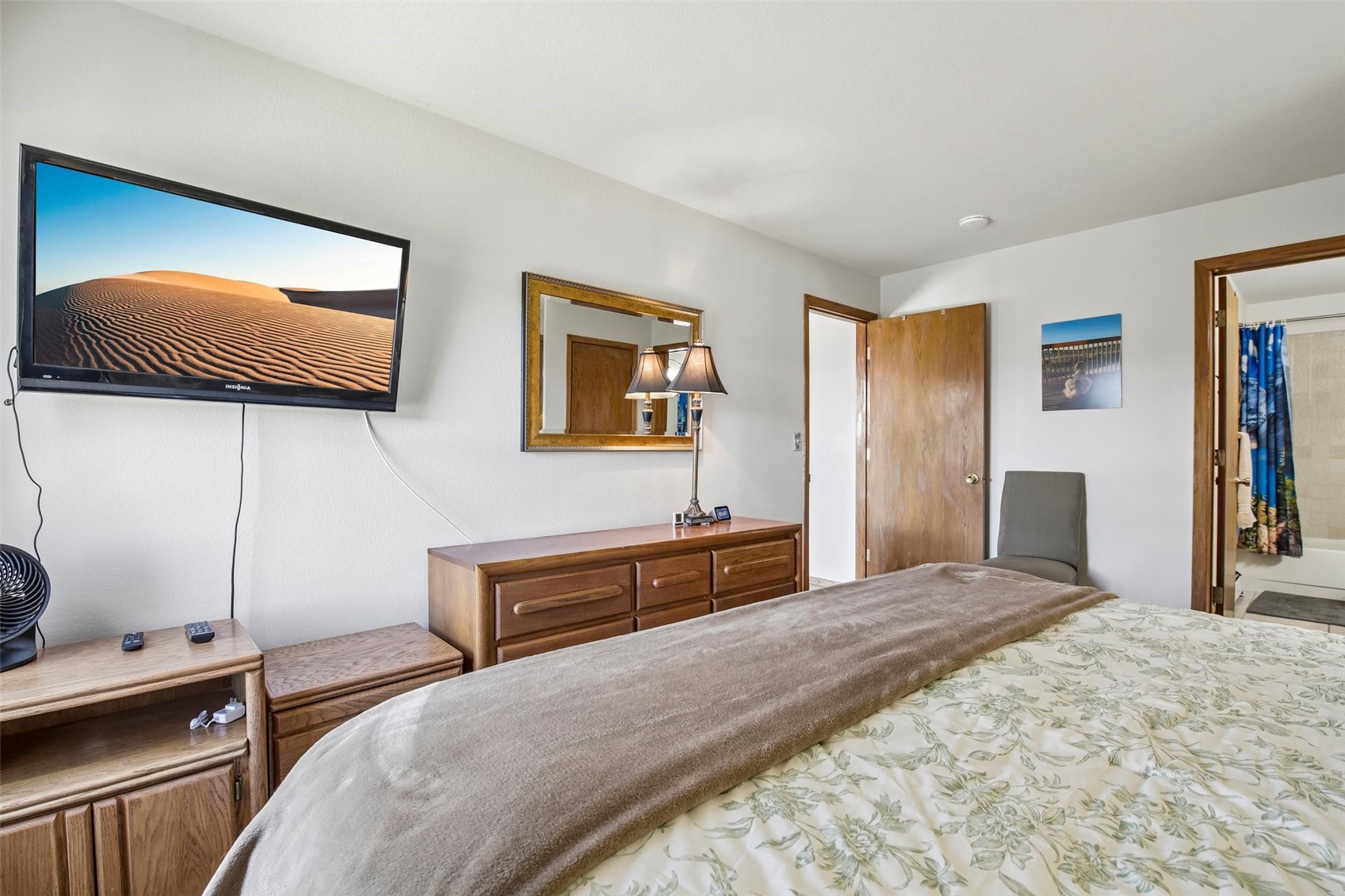 89310 Ryan Gulch Road, Unit 103 Silverthorne, CO 80498 - Photo 16 of 48 a bedroom with a bed and a painting on the wall