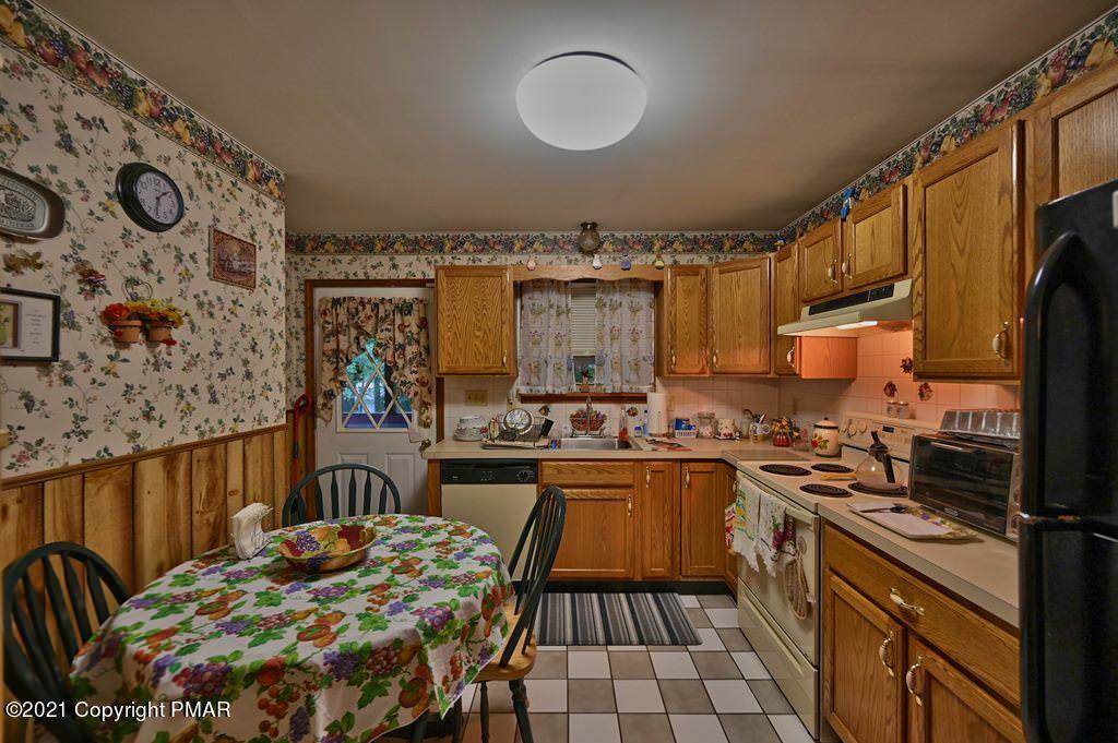 1607 Cotswald Road Tobyhanna, PA 18466 - Photo 13 of 61 a kitchen with a sink and wooden cabinets