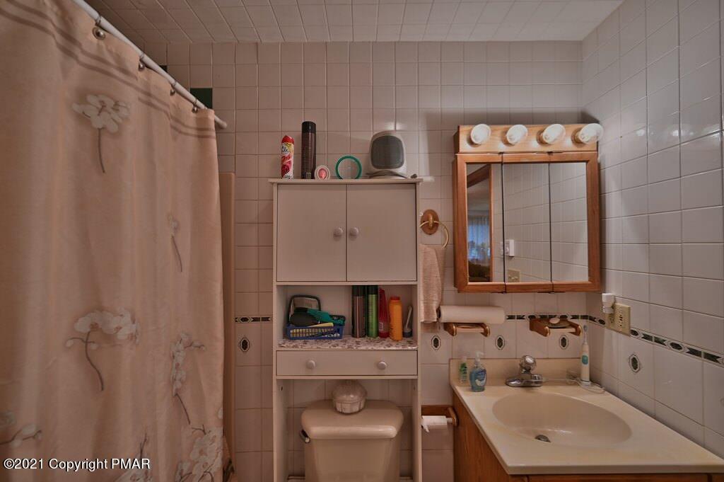 1607 Cotswald Road Tobyhanna, PA 18466 - Photo 24 of 61 a bathroom with a sink a toilet and shower