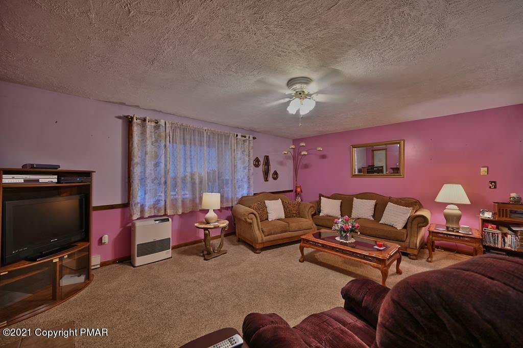 1607 Cotswald Road Tobyhanna, PA 18466 - Photo 8 of 61 a living room with furniture a flat screen tv and a window
